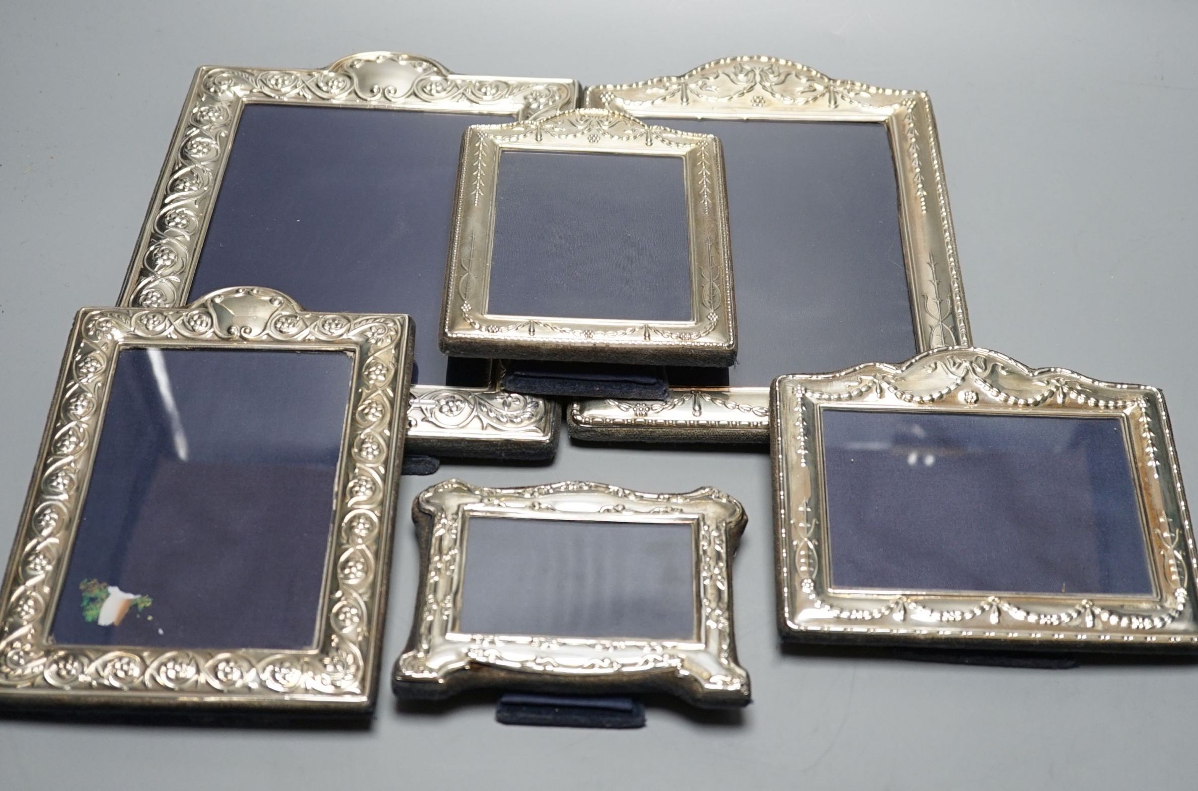 Two modern graduated pairs of decorated silver mounted photograph frames, Carrs of Sheffield, 2000 & 2001, largest 25.6cm and two smaller silver mounted frames.